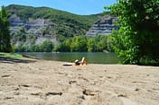Camping Arc en Ciel - Activities - Woman lying on the beach by the Ard&egrave;che