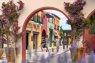 Le Brasilia campsite, services, family walking in the place du village esplanade