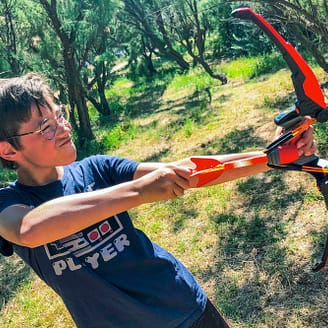 Le Brasilia campsite, activities, child playing on the Arrow Blaster