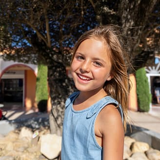 Camping Le Brasilia, services, place du village, enfant souriant