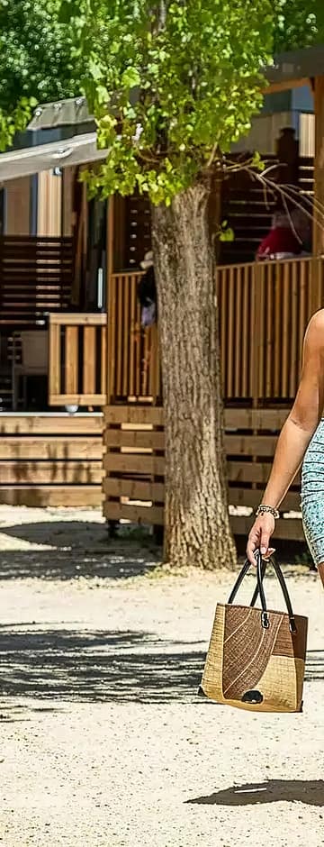 Camping Arc en Ciel - Accommodations - Couple walking next to their cottage