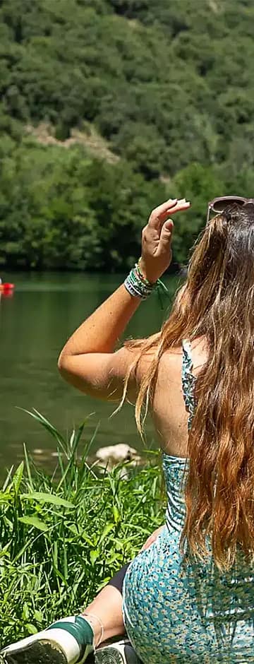 Camping Arc en Ciel - Activities - Couple sitting on the grass by the Ardèche