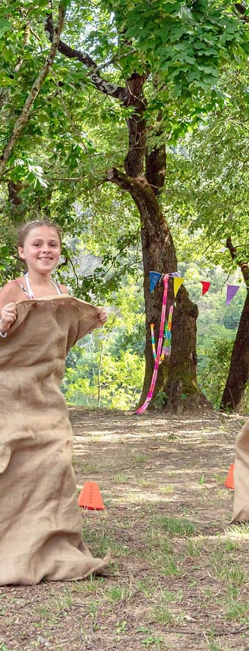 Camping Arc en Ciel - Activités - Enfants qui font une course de sac à patate